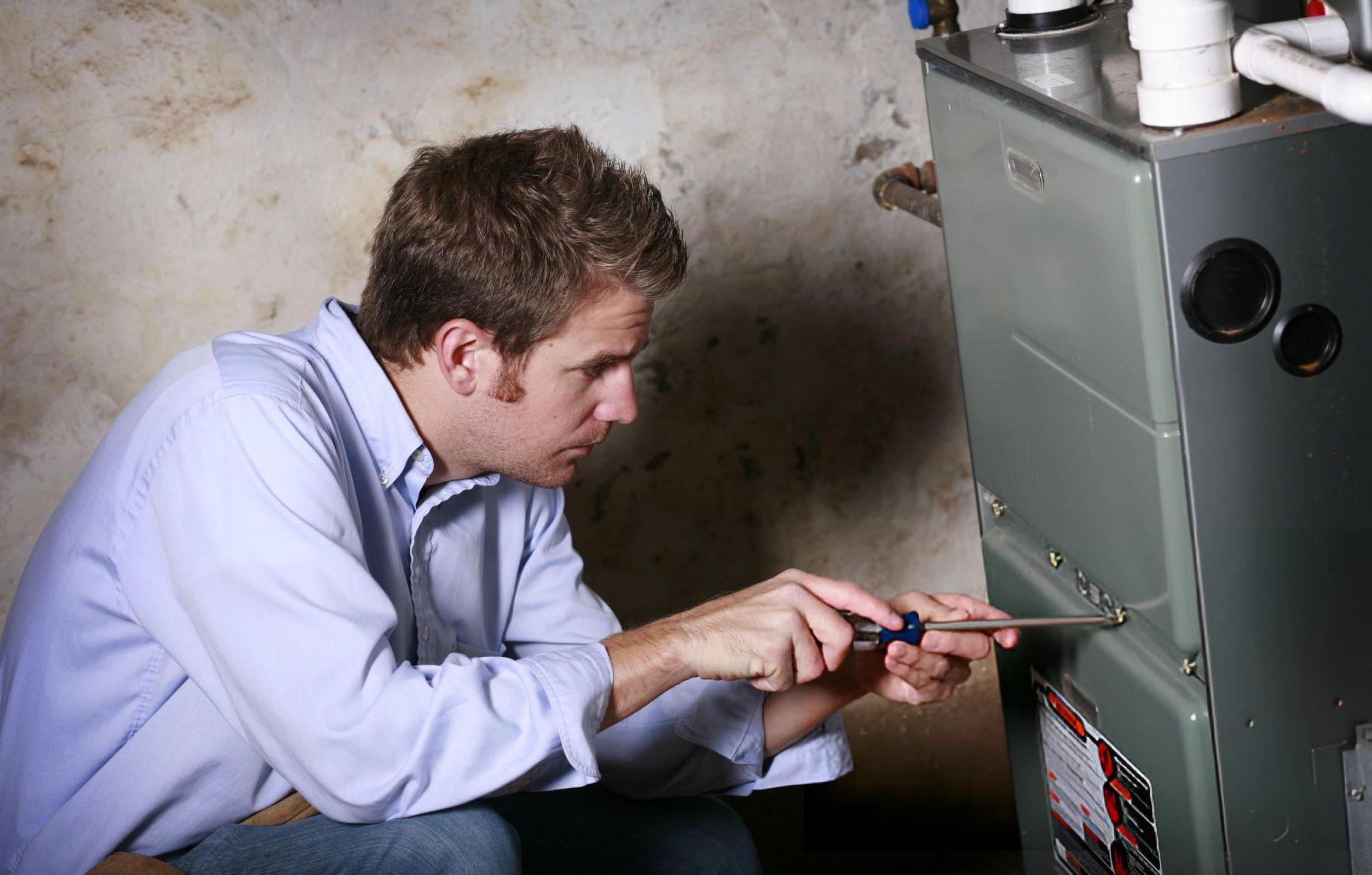 professional repairing the furnace